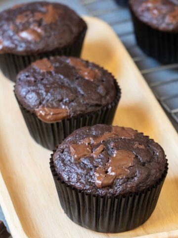 3 Chocolate Banana Muffins on a serving board